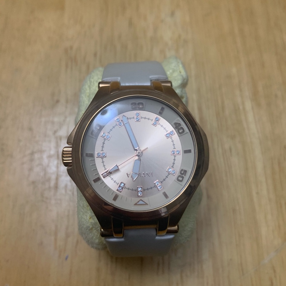 Rose Gold Invicta watch. The band is made of a silky cream color band.